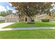 Traditional home featuring a large tree in the front yard and a two-car garage at 4531 River Overlook Dr, Valrico, FL 33596