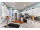 Bright kitchen featuring stainless steel appliances, white cabinets, granite countertops, and modern fixtures at 4531 River Overlook Dr, Valrico, FL 33596