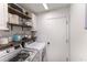Bright laundry room features open shelving, a washing machine, and dryer at 4531 River Overlook Dr, Valrico, FL 33596