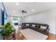 Bright living room featuring a leather sofa, ceiling fan, and sliding door to patio at 4531 River Overlook Dr, Valrico, FL 33596