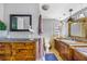 Spacious bathroom featuring dual vanities, custom cabinets, tile floors, and stylish fixtures and decor at 4916 Palmetto Point Dr, Palmetto, FL 34221