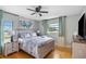 Cozy bedroom with wood floors, sea-themed decor, and a ceiling fan at 4916 Palmetto Point Dr, Palmetto, FL 34221