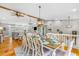 Bright and airy dining room featuring hardwood floors, wood beam accents, and staircase to a second story at 4916 Palmetto Point Dr, Palmetto, FL 34221