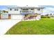 Charming home featuring a well-maintained lawn, garage, and staircase leading to a deck at 4916 Palmetto Point Dr, Palmetto, FL 34221