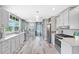 Bright, modern kitchen with stainless steel appliances, white cabinets, and a breakfast area with natural light at 4916 Palmetto Point Dr, Palmetto, FL 34221