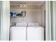 Laundry room featuring a modern washer and dryer with storage shelves for convenience at 4916 Palmetto Point Dr, Palmetto, FL 34221