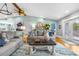 Spacious living room with hardwood floors, stylish furniture, and large windows allowing ample natural light at 4916 Palmetto Point Dr, Palmetto, FL 34221