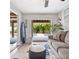 Comfortable living room with a view of the pool and tropical landscaping at 4916 Palmetto Point Dr, Palmetto, FL 34221
