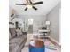 Cozy living room with a sofa, area rug, desk, and stairs leading to another level at 4916 Palmetto Point Dr, Palmetto, FL 34221