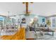 Open-concept living space with hardwood floors, stylish furniture, and seamless transition to the dining area at 4916 Palmetto Point Dr, Palmetto, FL 34221