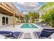 A beautiful outdoor pool area with lounge chairs and a view of the home's deck and surrounding landscape at 4916 Palmetto Point Dr, Palmetto, FL 34221