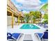 Beautiful pool with poolside seating surrounded by tropical landscaping, perfect for relaxation and outdoor entertaining at 4916 Palmetto Point Dr, Palmetto, FL 34221