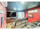 Home theater room with large screen TV, recliner seating, and themed decor at 4916 Palmetto Point Dr, Palmetto, FL 34221
