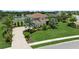 Beautiful home showcasing lush landscaping, a paver driveway, and a well-manicured lawn at 4973 Antiquity Way, Sarasota, FL 34240