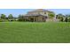 Expansive backyard features a large lawn area, perfect for outdoor activities and entertaining at 4973 Antiquity Way, Sarasota, FL 34240