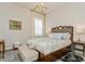 Bright bedroom boasts a decorative headboard, plush bedding, and neutral decor at 4973 Antiquity Way, Sarasota, FL 34240