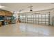 Spacious three car garage featuring epoxy floors, shelving, garage door openers, and plenty of room for storage at 4973 Antiquity Way, Sarasota, FL 34240