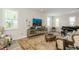 Sophisticated living room with large windows, plantation shutters, and stylish furnishings at 4973 Antiquity Way, Sarasota, FL 34240