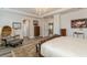 A spacious primary bedroom featuring wood-look floors, elegant chandelier, and neutral paint at 4973 Antiquity Way, Sarasota, FL 34240