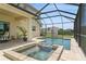 Relaxing screened-in pool and spa with brick surround offers the perfect outdoor retreat at 4973 Antiquity Way, Sarasota, FL 34240