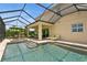 Backyard showcasing a pool, spa, covered lanai, and a lakeside view for ultimate relaxation and entertainment at 4973 Antiquity Way, Sarasota, FL 34240