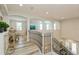 View of the home's second story staircase, detailed railing, open floor plan, and vinyl flooring at 4973 Antiquity Way, Sarasota, FL 34240