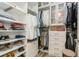 A stylish walk-in closet with custom shelves and hanging rods for maximum organization at 4973 Antiquity Way, Sarasota, FL 34240