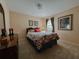 Cozy bedroom with a comfortable bed, decorative artwork, and soft lighting, creating a relaxing ambiance at 5004 Grainary Ave, Tampa, FL 33624
