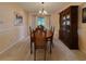 Classic dining room features a wood table, elegant chandelier, and china cabinet, perfect for Gathering gatherings at 5004 Grainary Ave, Tampa, FL 33624