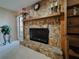 Close up of stone fireplace with mantle, decorative accents, and view of the adjacent living area at 5004 Grainary Ave, Tampa, FL 33624