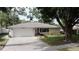 Charming single-story home featuring a well-maintained lawn and attached two-car garage in a desirable neighborhood at 5004 Grainary Ave, Tampa, FL 33624