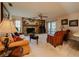 Inviting living room featuring a cozy stone fireplace, neutral carpet, and sliding glass doors leading to the patio at 5004 Grainary Ave, Tampa, FL 33624