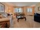 Comfortable living room showcasing plush sofas, a glass-top coffee table, and sunlit windows with elegant curtains at 5004 Grainary Ave, Tampa, FL 33624