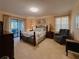 Spacious main bedroom with neutral walls, sliding glass doors to the patio, and coordinated furnishings at 5004 Grainary Ave, Tampa, FL 33624