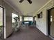 Inviting screened porch with brick accents, outdoor seating, and ceiling fans at 5004 Grainary Ave, Tampa, FL 33624