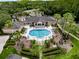 Overhead view of a community pool area, highlighting landscaped grounds, clear pool, and ample lounge seating at 5125 Palm Springs Blvd # 3108, Tampa, FL 33647