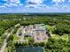 Aerial shot of commercial complex nestled amid verdant foliage and a serene pond under a beautiful cloudy sky at 5125 Palm Springs Blvd # 3108, Tampa, FL 33647