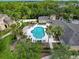 Aerial view of the community pool area, featuring a sparkling pool, comfortable lounge chairs, and lush landscaping at 5125 Palm Springs Blvd # 3108, Tampa, FL 33647