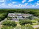 Overhead view of a commercial building with parking under a bright blue sky with sparse vegetation surrounding the property at 5125 Palm Springs Blvd # 3108, Tampa, FL 33647