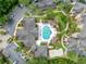 Aerial view of a neighborhood pool with lounge chairs surrounded by landscaping, parking, and apartment buildings at 5125 Palm Springs Blvd # 3108, Tampa, FL 33647