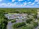 Commercial building surrounded by a pond and trees and a large parking lot under a beautiful blue cloudy sky at 5125 Palm Springs Blvd # 3108, Tampa, FL 33647