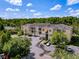 Aerial view of the condo building shows well-maintained grounds and ample parking at 5125 Palm Springs Blvd # 3108, Tampa, FL 33647