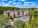 Aerial view of the condominium building showcasing well-maintained grounds and ample parking at 5125 Palm Springs Blvd # 3108, Tampa, FL 33647