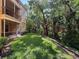 A well-maintained backyard featuring a grassy lawn and a wooded area at 5125 Palm Springs Blvd # 3108, Tampa, FL 33647