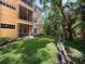 Backyard showing the building, screened patio, lawn, and wooded area at 5125 Palm Springs Blvd # 3108, Tampa, FL 33647