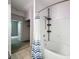 Bathroom showcasing a white tiled shower and tub with blue striped curtain at 5125 Palm Springs Blvd # 3108, Tampa, FL 33647