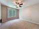 Carpeted bedroom featuring a ceiling fan and a large window at 5125 Palm Springs Blvd # 3108, Tampa, FL 33647