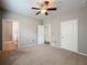 Spacious bedroom showcasing carpeted floors, a ceiling fan, and access to a bathroom at 5125 Palm Springs Blvd # 3108, Tampa, FL 33647