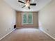 Bright carpeted bedroom with a ceiling fan and large window at 5125 Palm Springs Blvd # 3108, Tampa, FL 33647