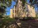 Exterior view of a building with screened patios, set amongst lush trees at 5125 Palm Springs Blvd # 3108, Tampa, FL 33647